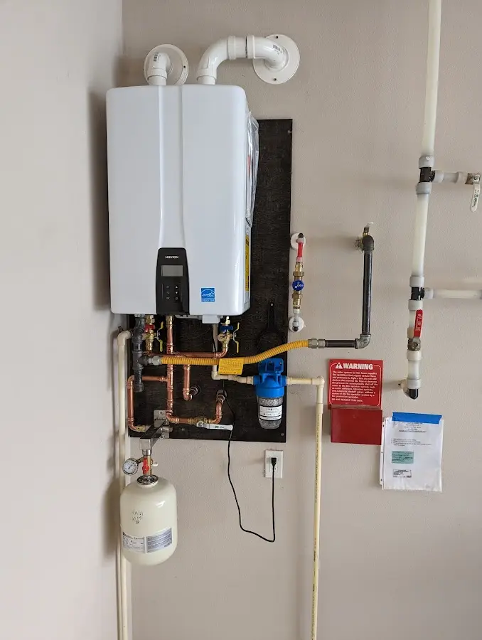 Professional plumber installing copper piping in a Lake Dallas home